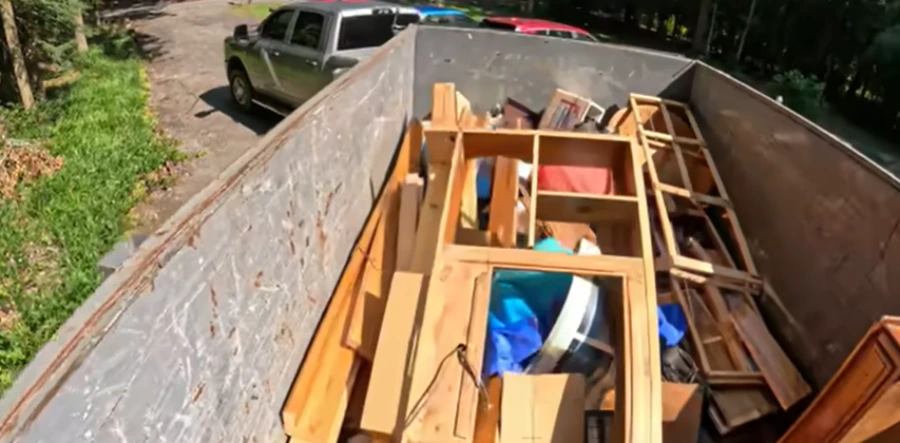Old sectional couch being carried out during furniture removal in Evansville IN